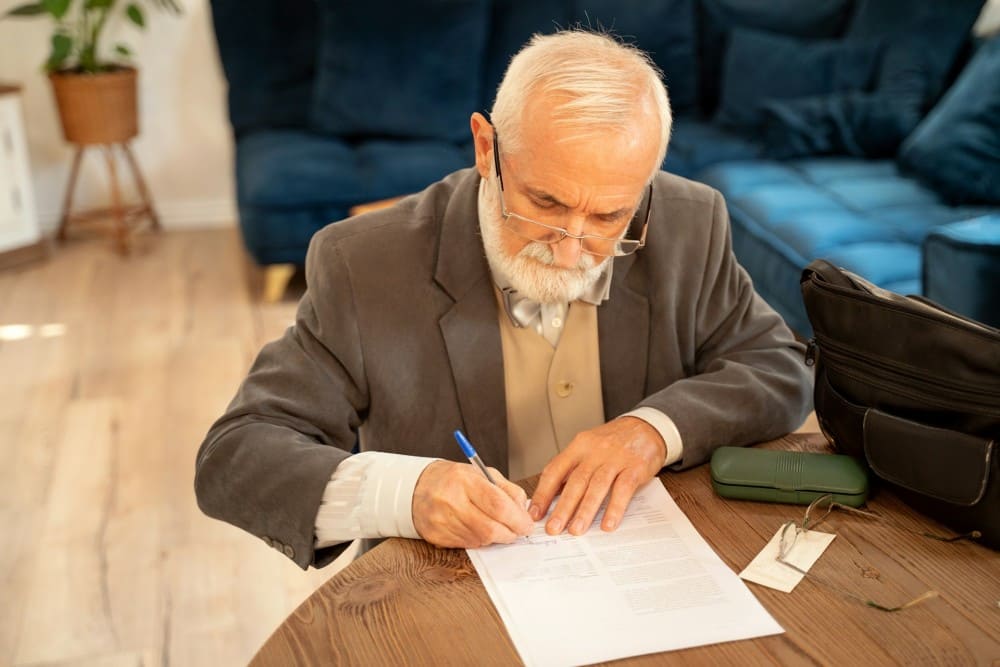 Senior signant un contrat de mutuelle